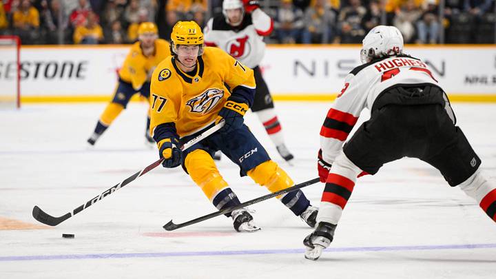 Feb 23, 2025; Nashville, Tennessee, USA;  Nashville Predators right wing Luke Evangelista (77) skates with the puck against the New Jersey Devils during the third half at Bridgestone Arena. Mandatory Credit: Steve Roberts-Imagn Images