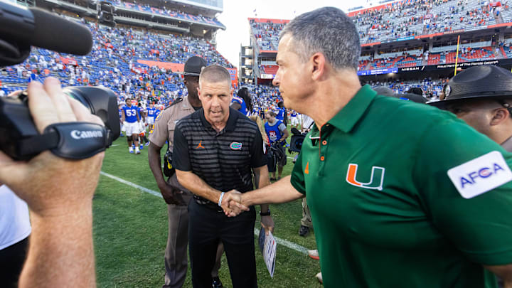 Florida Gators head coach Billy Napier, left shakes hands with Miami Hurricanes head coach Mario Cristobal after the Hurricanes defeated the Gators during the season opener at Ben Hill Griffin Stadium in Gainesville, FL on Saturday, August 31, 2024 against the University of Miami Hurricanes. The Hurricanes defeated the Gators 41-17. [Doug Engle/Gainesville Sun]