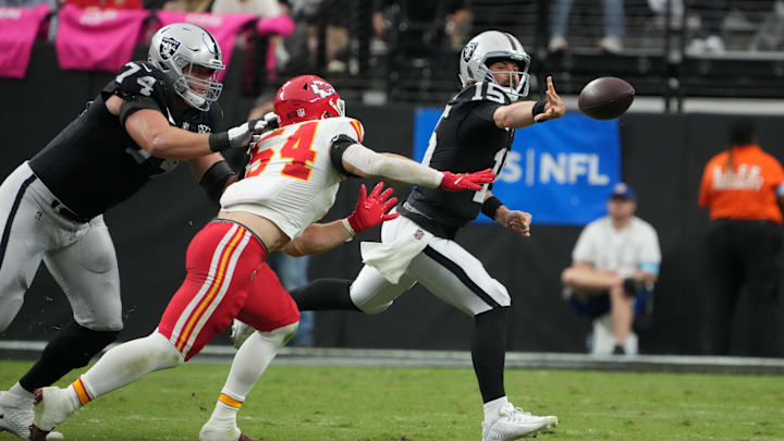 Oct 27, 2024; Paradise, Nevada, USA; Las Vegas Raiders quarterback Gardner Minshew (15) throws the ball against Kansas City Chiefs linebacker Leo Chenal (54) in the first half at Allegiant Stadium. Mandatory Credit: Kirby Lee-Imagn Images