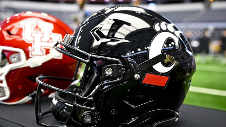 Jul 12, 2023; Arlington, TX, USA; A view of the Cincinnati Bearcats helmet and logo during Big 12 football media day at AT&T Stadium. Mandatory Credit: Jerome Miron-Imagn Images Jul 12, 2023; Arlington, TX, USA; A view of the Cincinnati Bearcats helmet and logo during Big 12 football media day at AT&T Stadium. Mandatory Credit: Jerome Miron-Imagn Images