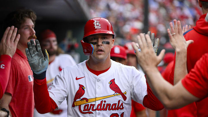 Jun 5, 2025; St. Louis, Missouri, USA;  St. Louis Cardinals left fielder Lars Nootbaar (21) is congratulated by teammates after scoring against the Kansas City Royals during the first inning at Busch Stadium. Mandatory Credit: Jeff Curry-Imagn Images