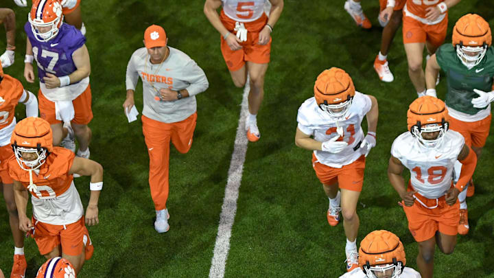Clemson head coach Dabo Swinney and the team run from indoors to outside during the first football practice at the Allen N. Reeves Football Complex at Clemson University in Clemson, S.C. Friday, February 28, 2025.