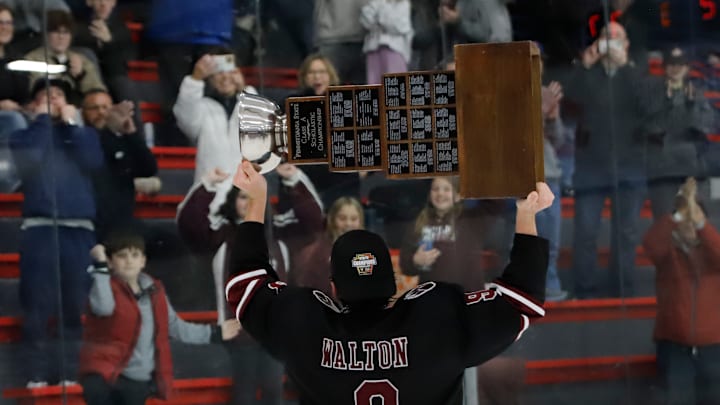 Garnet Valley forward Kevin Walton raises the Pennsylvania state hockey champion toward the Jaguars' faithful that made the 300-mile trip to see the Jaguars play Saturday at the RMU Island Sports Center. Walton scored twice in the 7-2 win.