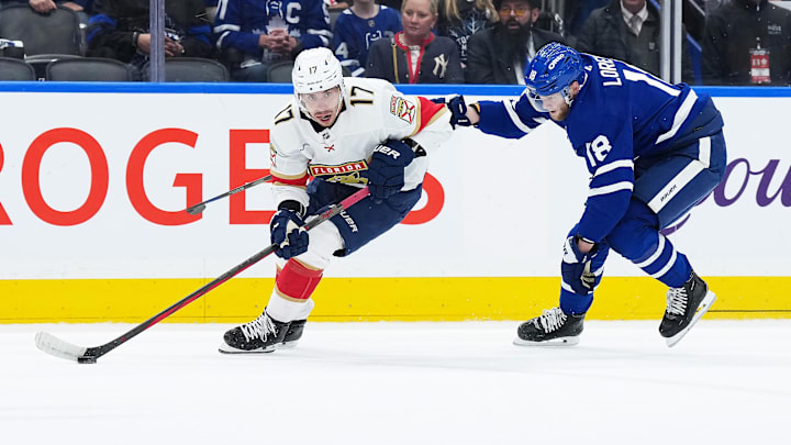 May 7, 2025; Toronto, Ontario, CAN; Florida Panthers center Evan Rodrigues (17) skates with the puck as Toronto Maple Leafs center Steven Lorentz (18) gives chase during the first period in game two of the second round of the 2025 Stanley Cup Playoffs at Scotiabank Arena. Mandatory Credit: Nick Turchiaro-Imagn Images