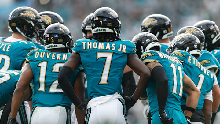 Dec 15, 2024; Jacksonville, Florida, USA; Jacksonville Jaguars wide receiver Brian Thomas Jr. (7), wide receiver Devin Duvernay (12), wide receiver Parker Washington (11), running back Travis Etienne Jr. (1) and the offense huddle against the New York Jets during the second quarter at EverBank Stadium. Mandatory Credit: Morgan Tencza-Imagn Images