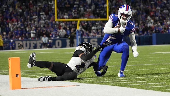 Buffalo Bills wide receiver Joshua Palmer runs the ball against Baltimore Ravens cornerback Nate Wiggins.