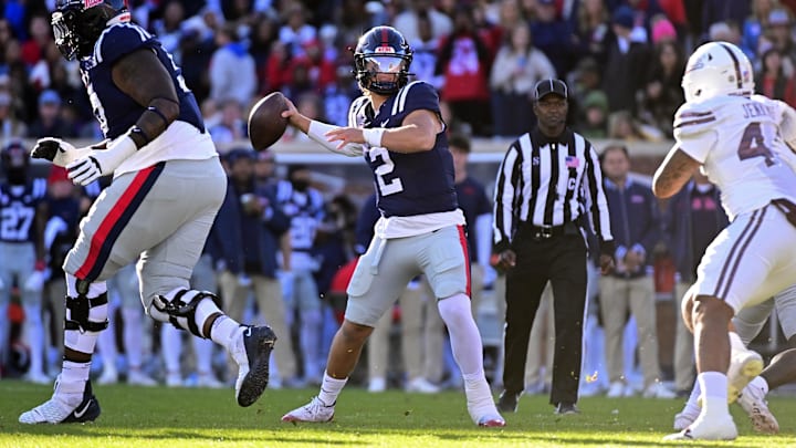 Nov 29, 2024; Oxford, Mississippi, USA;  Mississippi Rebels quarterback Jaxson Dart (2) looks to pass while defended by Mississippi State Bulldogs linebacker Branden Jennings (44) during the first quarter at Vaught-Hemingway Stadium. Mandatory Credit: Matt Bush-Imagn Images