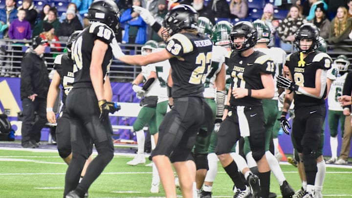 Shea Stevenson and Benson Jenks celebrate a tackle in Royal's WIAA Class 1A championship game win over Lakeside of Nine Mile Falls in 2023.