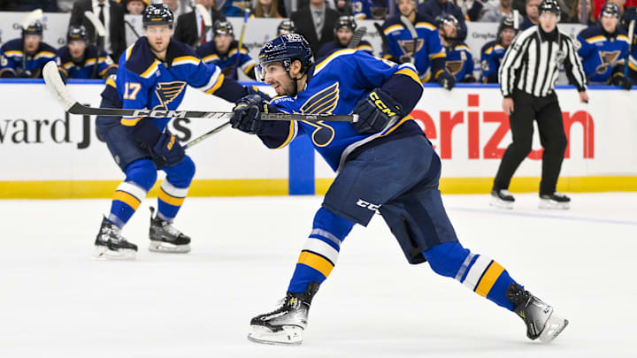 Dec 17, 2024; St. Louis, Missouri, USA;  St. Louis Blues center Jordan Kyrou (25) shoots against the New Jersey Devils during the second period at Enterprise Center. Mandatory Credit: Jeff Curry-Imagn Images