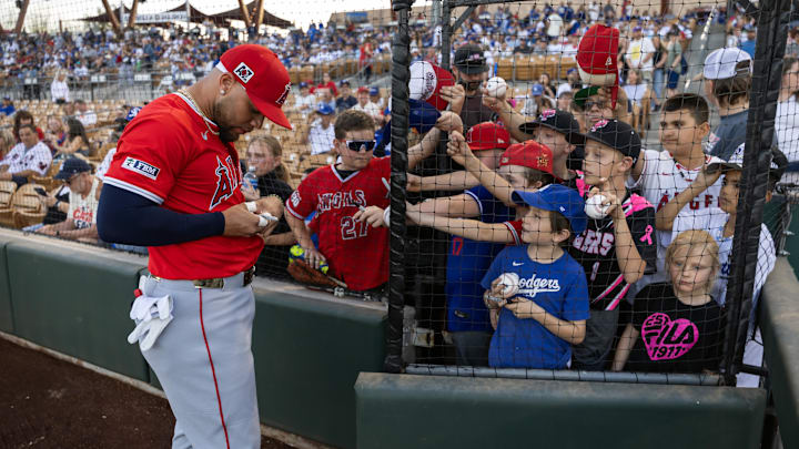 Feb 28, 2025; Phoenix, Arizona, USA; Los Angeles Angels third baseman Yoan Moncada signs autographs prior to the game against the Los Angeles Dodgers during spring training at Camelback Ranch-Glendale. Mandatory Credit: Mark J. Rebilas-Imagn Images