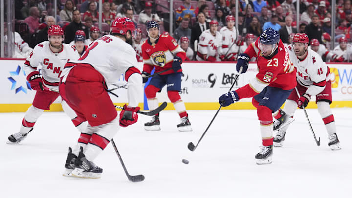 Jan 2, 2025; Sunrise, Florida, USA; Florida Panthers center Carter Verhaeghe (23) shoots the puck against the Carolina Hurricanes during the third period at Amerant Bank Arena. Mandatory Credit: Rich Storry-Imagn Images