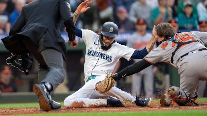 Seattle Mariners shortstop J.P. Crawford (center) is tagged out at home during a game against the Baltimore Orioles on June 4 at T-Mobile Park. Seattle Mariners shortstop J.P. Crawford (center) is tagged out at home during a game against the Baltimore Orioles on June 4 at T-Mobile Park.