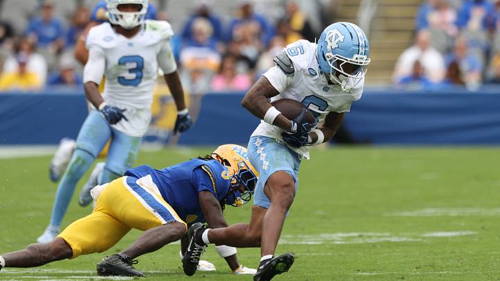Oct 10, 2026; Pittsburgh, Pennsylvania, USA; North Carolina Tar Heels defensive back Tre Miller (6) returns an interception against Pittsburgh Panthers running back Justin Cook (5) during the third quarter at Acrisure Stadium. Mandatory Credit: Charles LeClaire-Imagn Images Oct 10, 2026; Pittsburgh, Pennsylvania, USA; North Carolina Tar Heels defensive back Tre Miller (6) returns an interception against Pittsburgh Panthers running back Justin Cook (5) during the third quarter at Acrisure Stadium. Mandatory Credit: Charles LeClaire-Imagn Images
