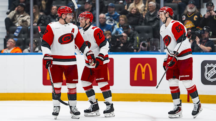 Mar 4, 2026; Vancouver, British Columbia, CAN; Carolina Hurricanes forward William Carrier (28) and forward Nikolaj Ehlers (27) and forward Jesperi Kotkaniemi (82) celebrate Ehlers’ second goal of the period against the Vancouver Canucks in the second at Rogers Arena. Mandatory Credit: Bob Frid-Imagn Images