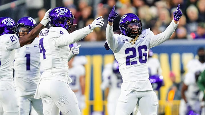 TCU's defense celebrates in a 23-17 win over West Virginia.