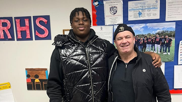Bill O'Brien alongside 2026 offensive lineman prospect Lawrence Iyalekhue. 
