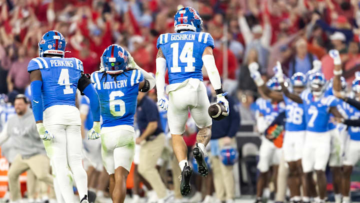 Jan 8, 2026; Glendale, AZ, USA; Mississippi Rebels safety Kapena Gushiken (14) celebrates an interception against the Miami Hurricanes during the 2026 Fiesta Bowl and semifinal game of the College Football Playoff at State Farm Stadium. Mandatory Credit: Mark J. Rebilas-Imagn Images