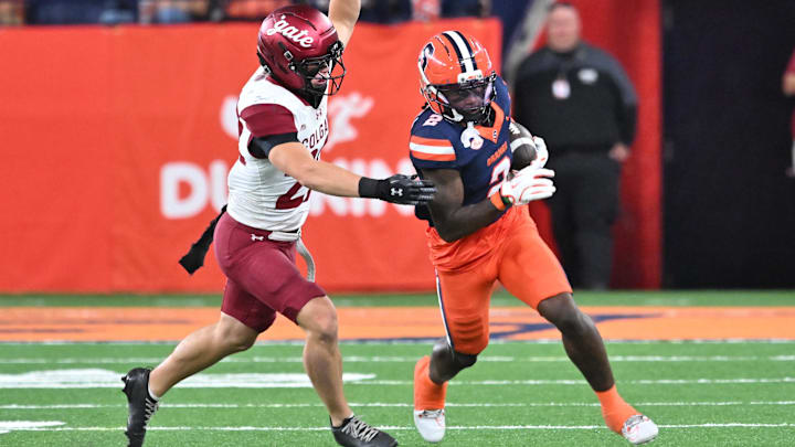 Sep 12, 2025; Syracuse, New York, USA; Syracuse Orange wide receiver Johntay Cook (2) runs from Colgate Raiders defensive back Kenny Langston (22) after making a catch in the second quarter quarter at the JMA Wireless Dome. Mandatory Credit: Mark Konezny-Imagn Images