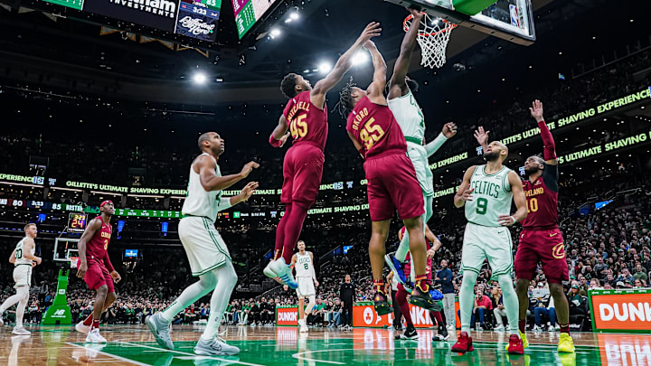 Dec 14, 2023; Boston, Massachusetts, USA; Boston Celtics guard Jaylen Brown (7) shoots against Cleveland Cavaliers guard Donovan Mitchell (45) and forward Isaac Okoro (35) in the second half at TD Garden. Mandatory Credit: David Butler II-Imagn Images