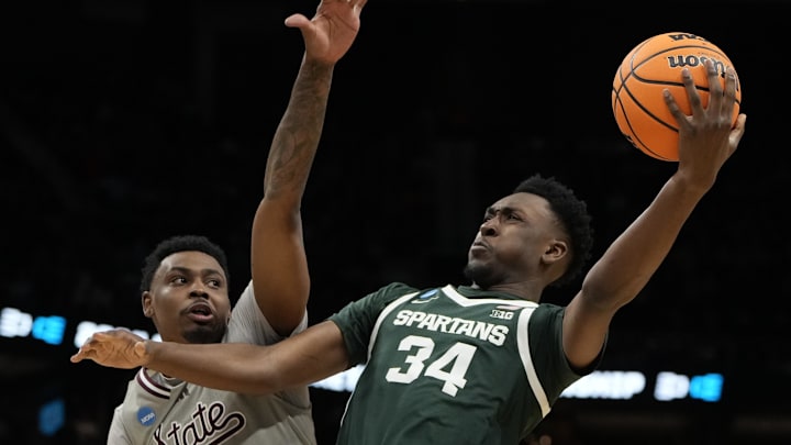 March 21, 2024, Charlotte, NC, USA; Michigan State Spartans forward Xavier Booker (34) shoots against Mississippi State Bulldogs forward D.J. Jeffries (0) in the first round of the 2024 NCAA Tournament at the Spectrum Center. Mandatory Credit: Bob Donnan-Imagn Images