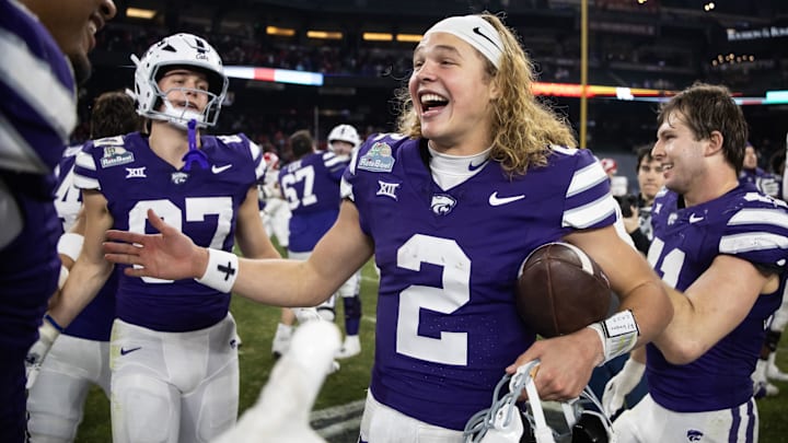 Dec 26, 2024; Phoenix, AZ, USA; Kansas State Wildcats quarterback Avery Johnson (2) celebrates after defeating the Rutgers Scarlet Knights during the Rate Bowl at Chase Field. Mandatory Credit: Mark J. Rebilas-Imagn Images Dec 26, 2024; Phoenix, AZ, USA; Kansas State Wildcats quarterback Avery Johnson (2) celebrates after defeating the Rutgers Scarlet Knights during the Rate Bowl at Chase Field. Mandatory Credit: Mark J. Rebilas-Imagn Images