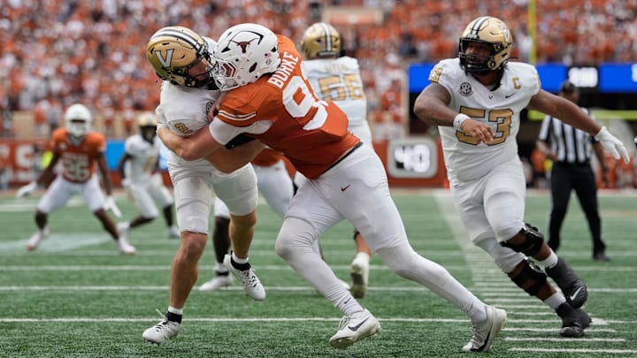 Nov 1, 2025; Austin, Texas, USA; Texas Longhorns defensive lineman Ethan Burke (91) sacks Vanderbilt Commodores quarterback Diego Pavia (2) on the one yard line during the second half at Darrell K Royal-Texas Memorial Stadium. Mandatory Credit: Scott Wachter-Imagn Images