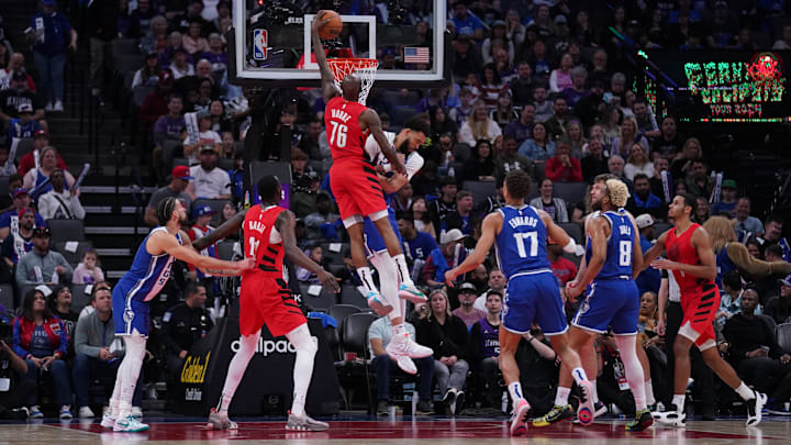 Apr 14, 2024; Sacramento, California, USA; Portland Trail Blazers guard Taze Moore (76) dunks over Sacramento Kings center JaVale McGee (00) in the fourth quarter at the Golden 1 Center. Mandatory Credit: Cary Edmondson-Imagn Images
