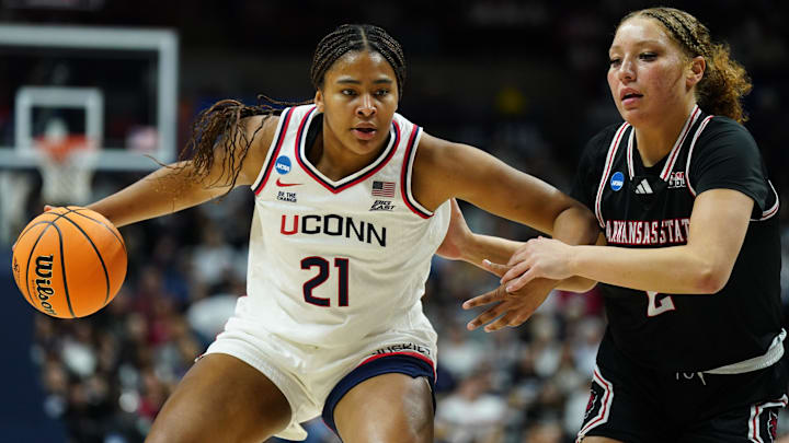 Mar 22, 2025; Storrs, Connecticut, USA; UConn Huskies forward Sarah Strong (21) drives the ball against Arkansas State Red Wolves guard Wynter Rogers (2) in the first half at Harry A. Gampel Pavilion. Mandatory Credit: David Butler II-Imagn Images