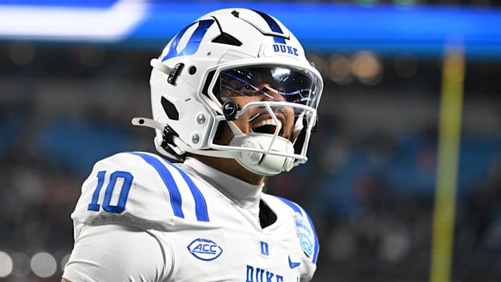 Dec 6, 2025; Charlotte, NC, USA; Duke Blue Devils quarterback Darian Mensah (10) celebrates after the Blue Devils score a touchdown in overtime during the  ACC Championship game at Bank of America Stadium. Mandatory Credit: Bob Donnan-Imagn Images