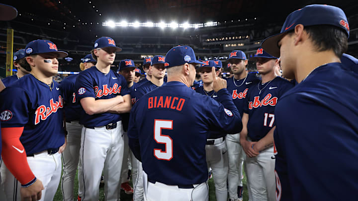 Ole Miss baseball coach Mike Bianco talks to players before the game against the Texas Longhorns at the Shriners Children's College Showdown in Arlington, Texas.