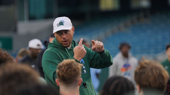 Tulane football coach Jon Sumrall talks to his troops during a practice session.