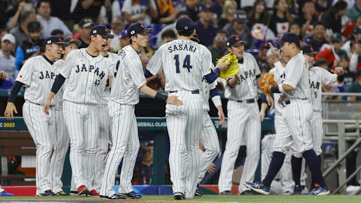 Mar 20, 2023; Miami, Florida, USA; Japan starting pitcher Roki Sasaki (14) celebrates with teammates after the first inning against Mexico at LoanDepot Park. Mandatory Credit: Sam Navarro-Imagn Images