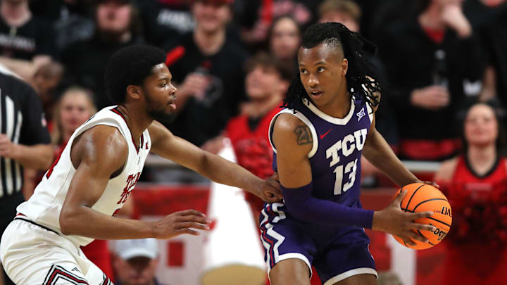 Jan 29, 2025; Lubbock, Texas, USA; Texas Christian Horned Frogs forward Trazarien White (13) holds the ball against Texas Tech Red Raiders guard Kerwin Walton (24) in the second half at United Supermarkets Arena. Mandatory Credit: Michael C. Johnson-Imagn Images Jan 29, 2025; Lubbock, Texas, USA; Texas Christian Horned Frogs forward Trazarien White (13) holds the ball against Texas Tech Red Raiders guard Kerwin Walton (24) in the second half at United Supermarkets Arena. Mandatory Credit: Michael C. Johnson-Imagn Images