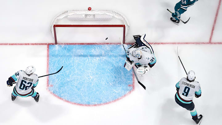 Nov 29, 2024; San Jose, California, USA; San Jose Sharks center Mikael Granlund (64) reacts after scoring a goal against Seattle Kraken goaltender Philipp Grubauer (31), defenseman Brandon Montour (62) and center Chandler Stephenson (9) during the second period at SAP Center at San Jose. Mandatory Credit: Robert Edwards-Imagn Images