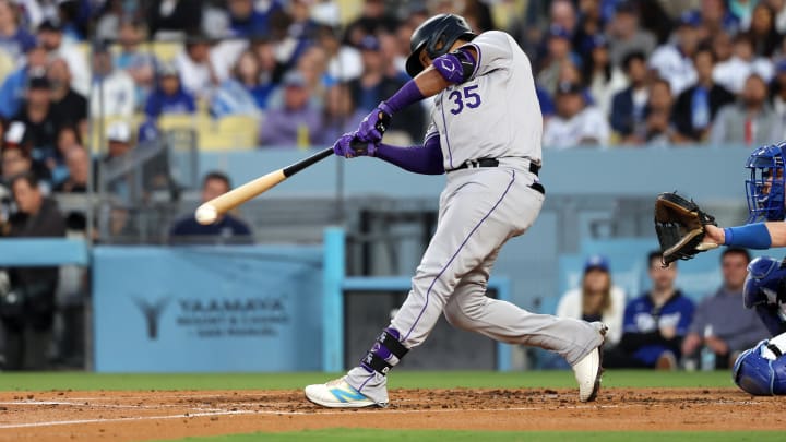 Jun 1, 2024; Los Angeles, California, USA;  Colorado Rockies catcher Elias Diaz (35) hits a single during the third inning against the Los Angeles Dodgers at Dodger Stadium.