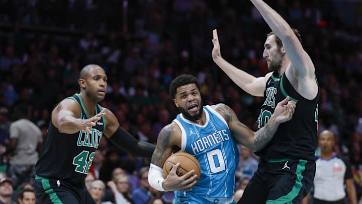 Nov 2, 2024; Charlotte, North Carolina, USA; Charlotte Hornets forward Miles Bridges (0) drives between Boston Celtics center Luke Kornet (40) and center Al Horford (42) during the second half at Spectrum Center. Mandatory Credit: Nell Redmond-Imagn Images Nov 2, 2024; Charlotte, North Carolina, USA; Charlotte Hornets forward Miles Bridges (0) drives between Boston Celtics center Luke Kornet (40) and center Al Horford (42) during the second half at Spectrum Center. Mandatory Credit: Nell Redmond-Imagn Images