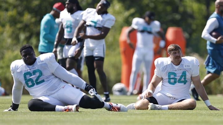 Miami Dolphins guard Germain Ifedi (62) and offensive tackle Daniel Brunskill (64) stretch during joint training camp practice with the Chicago Bears ahead of Sunday's preseason opener. Miami Dolphins guard Germain Ifedi (62) and offensive tackle Daniel Brunskill (64) stretch during joint training camp practice with the Chicago Bears ahead of Sunday's preseason opener.