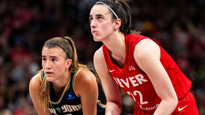 Jul 6, 2024; Indianapolis, Indiana, USA; New York Liberty guard Sabrina Ionescu (20) and Indiana Fever guard Caitlin Clark (22) watch a free throw at Gainbridge Fieldhouse. Mandatory Credit: Grace Smith/INDIANAPOLIS STAR-Imagn Images