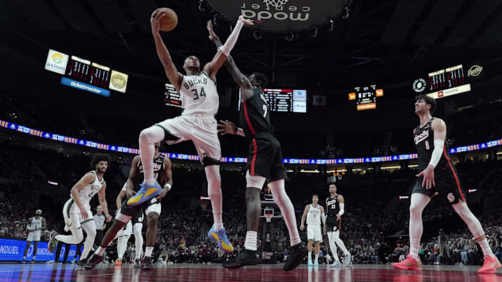 Jan 28, 2025; Portland, Oregon, USA; Milwaukee Bucks power forward Giannis Antetokounmpo (34) shoots the ball against Portland Trail Blazers center Deandre Ayton (2) during the second half at Moda Center. Mandatory Credit: Soobum Im-Imagn Images
