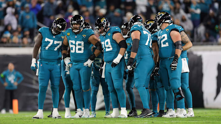 Dec 17, 2023; Jacksonville, Florida, USA;  Jacksonville Jaguars offensive tackle Anton Harrison (77) guard Brandon Scherff (68) center Luke Fortner (79) Jacksonville Jaguars guard Ezra Cleveland (76)and offensive tackle Walker Little (72) huddle against the Baltimore Ravens in the first quarter at EverBank Stadium. Mandatory Credit: Nathan Ray Seebeck-Imagn Images