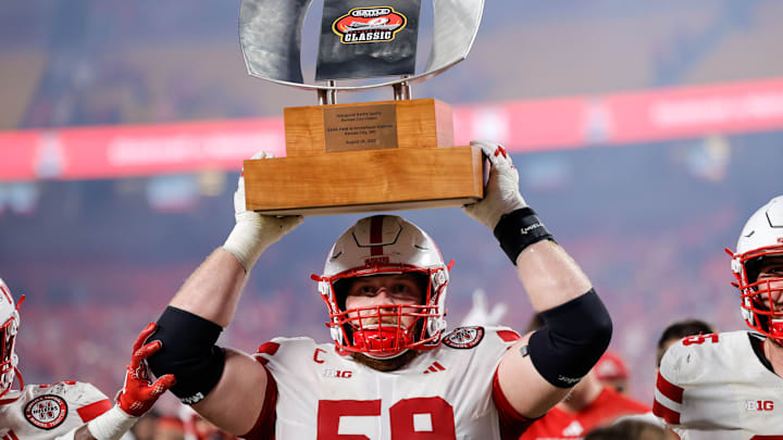 Nebraska offensive lineman Henry Lutovsky holds up the Battle Sports Kansas City Classic trophy after defeating Cincinnati at Arrowhead Stadium. 
