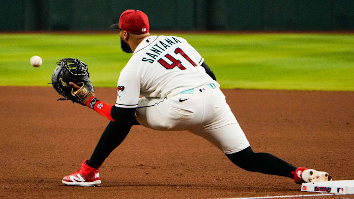 Apr 2, 2026; Phoenix, Arizona, USA; Arizona Diamondbacks first baseman Carlos Santana (41) makes a play at first during the fourth inning at Chase Field. Mandatory Credit: Arianna Grainey-Imagn Images
