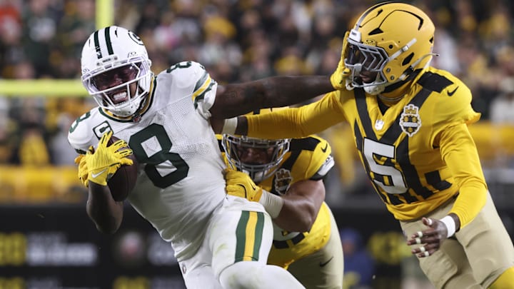 Oct 26, 2025; Pittsburgh, Pennsylvania, USA;  Green Bay Packers running back Josh Jacobs (8) stiff arms Pittsburgh Steelers cornerback Jalen Ramsey (5) during the third quarter at Acrisure Stadium.