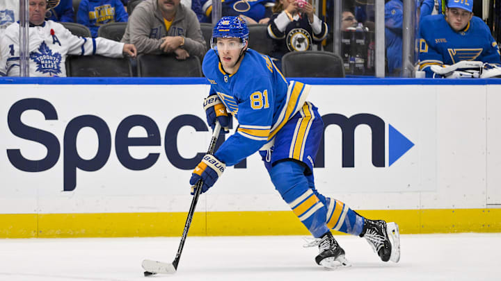 Nov 2, 2024; St. Louis, Missouri, USA;  St. Louis Blues center Dylan Holloway (81) controls the puck against the Toronto Maple Leafs during the second period at Enterprise Center. Mandatory Credit: Jeff Curry-Imagn Images