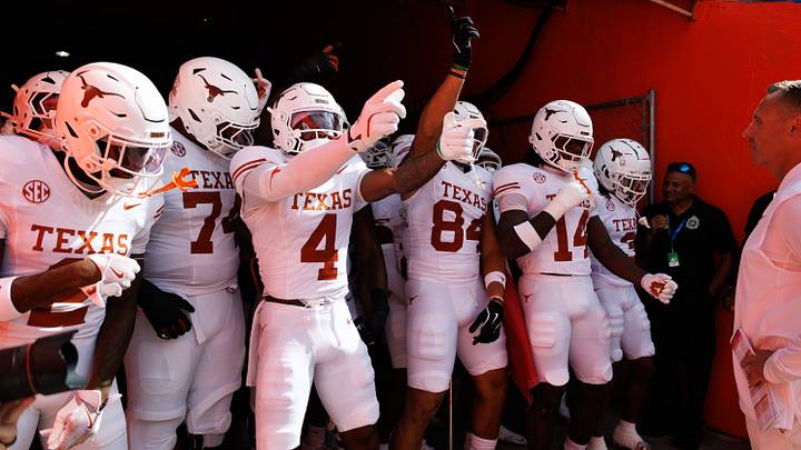 Texas Longhorns running back CJ Baxter (4) and Texas Longhorns tight end Jordan Washington (84) gesture with teammates before a game against the Florida Gators at Ben Hill Griffin Stadium. Texas Longhorns running back CJ Baxter (4) and Texas Longhorns tight end Jordan Washington (84) gesture with teammates before a game against the Florida Gators at Ben Hill Griffin Stadium.