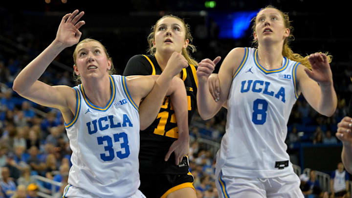 Feb 1, 2026; Los Angeles, California, USA;  UCLA Bruins forward Amanda Muse (33) and guard Gianna Kneepkens (8) box out Iowa Hawkeyes center Layla Hays (12) in the second half at Pauley Pavilion presented by Wescom Financial. Mandatory Credit: Jayne Kamin-Oncea-Imagn Images