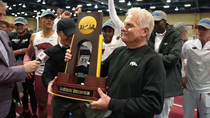 Mar 11, 2023; Albuquerque, New Mexico, USA; Arkansas Razorbacks coach Chris Bucknam holds the team championship trophy during the NCAA Indoor Championships at Albuquerque Convention Center. Mandatory Credit: Kirby Lee-USA TODAY Sports