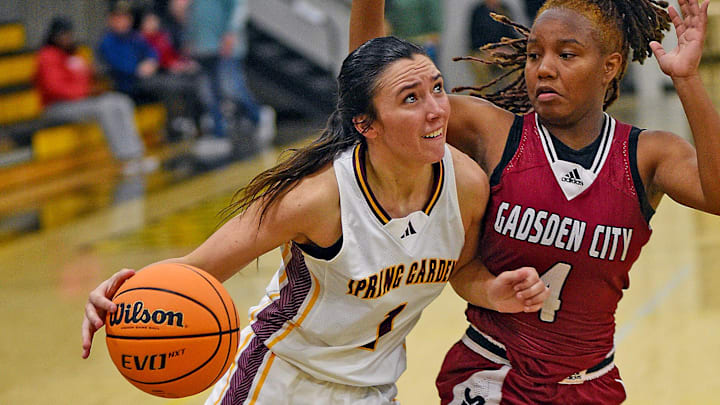 Spring GardenÕs Ace Austin drives to the basket as Gadsden CityÕs Destiny Whiteside defends during high school girls basketball action in Centre, Alabama , Alabama December 20, 2024. (Dave Hyatt / Hyatt Media LLC)