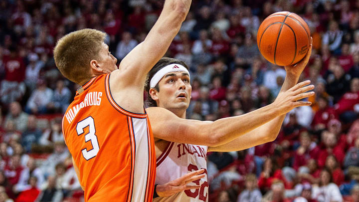 Indiana's Trey Galloway (32) looks to shoot past Illinois' Kasparas Jakucionis (32) during Illinois' 94-69 win on Tuesday.  