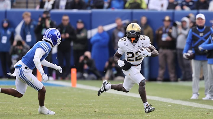 Nov 29, 2025; Provo, Utah, USA; UCF Knights running back Myles Montgomery (22) runs against BYU Cougars safety Raider Damuni (3) during the second half at LaVell Edwards Stadium. Mandatory Credit: Rob Gray-Imagn Images Nov 29, 2025; Provo, Utah, USA; UCF Knights running back Myles Montgomery (22) runs against BYU Cougars safety Raider Damuni (3) during the second half at LaVell Edwards Stadium. Mandatory Credit: Rob Gray-Imagn Images
